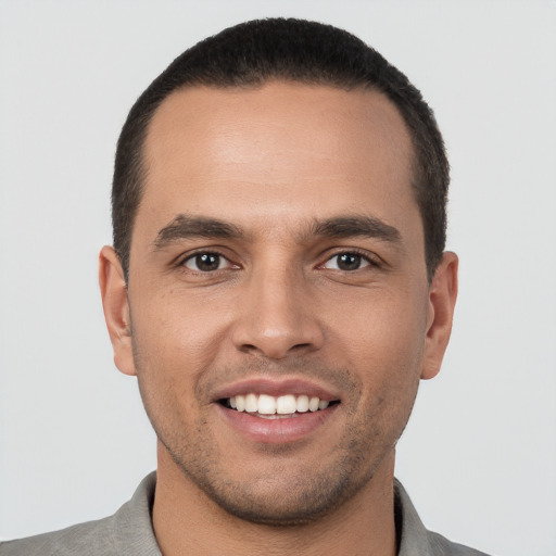 Joyful white young-adult male with short  black hair and brown eyes