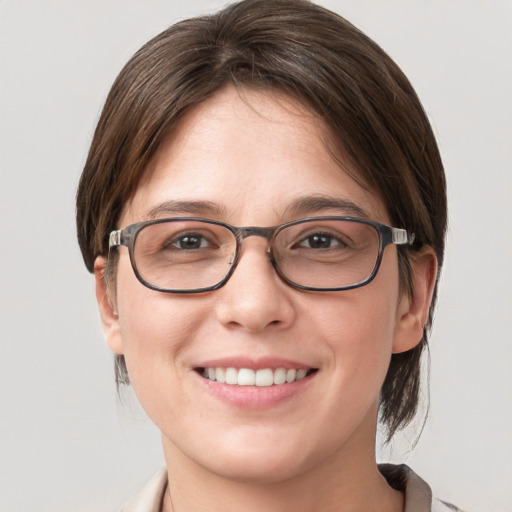 Joyful white young-adult female with medium  brown hair and blue eyes