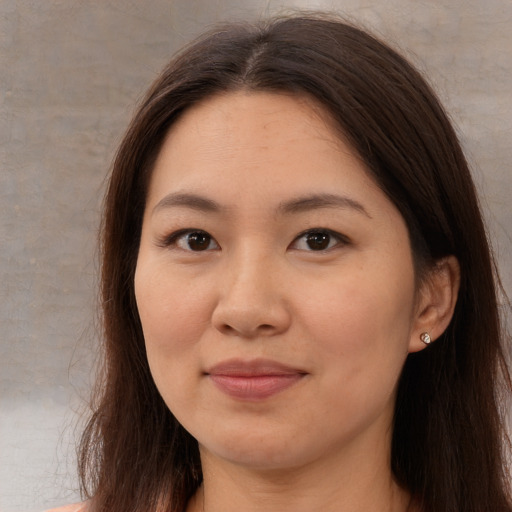Joyful asian young-adult female with long  brown hair and brown eyes