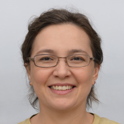 Joyful white adult female with medium  brown hair and brown eyes