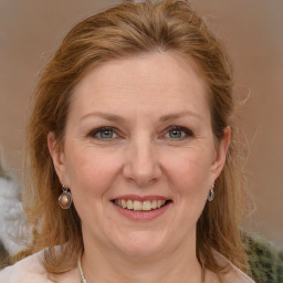 Joyful white adult female with medium  brown hair and grey eyes