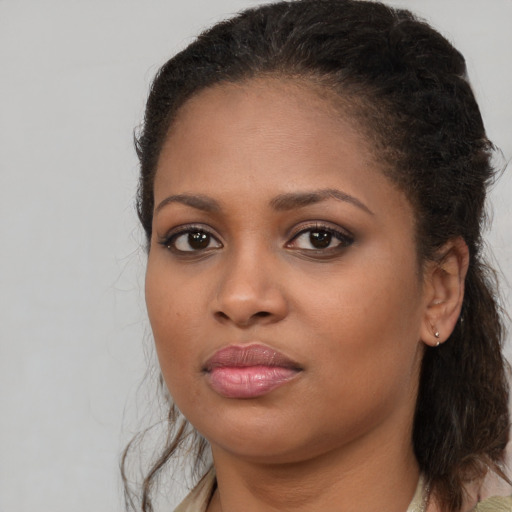 Joyful black young-adult female with medium  brown hair and brown eyes