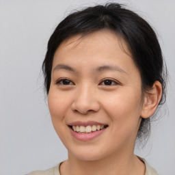 Joyful asian young-adult female with medium  brown hair and brown eyes