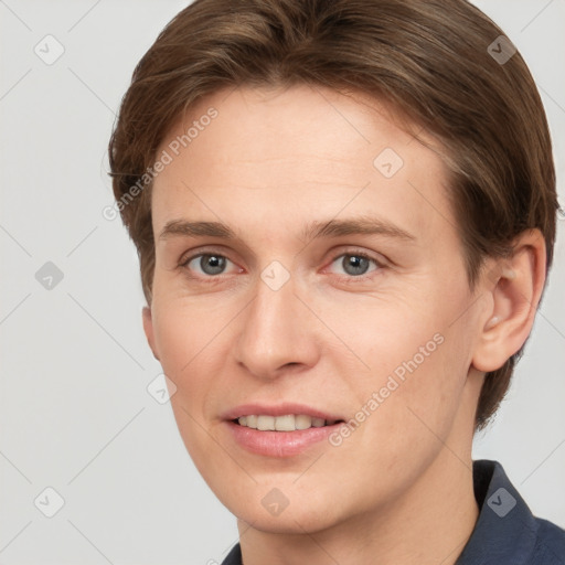 Joyful white young-adult female with short  brown hair and grey eyes