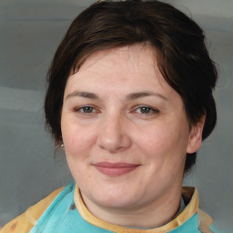 Joyful white adult female with medium  brown hair and brown eyes