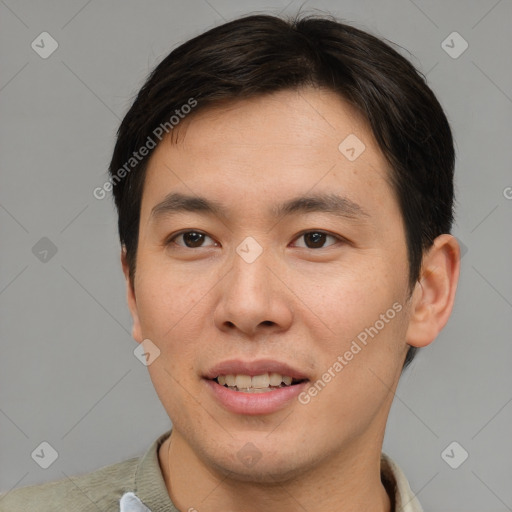 Joyful asian young-adult male with short  brown hair and brown eyes