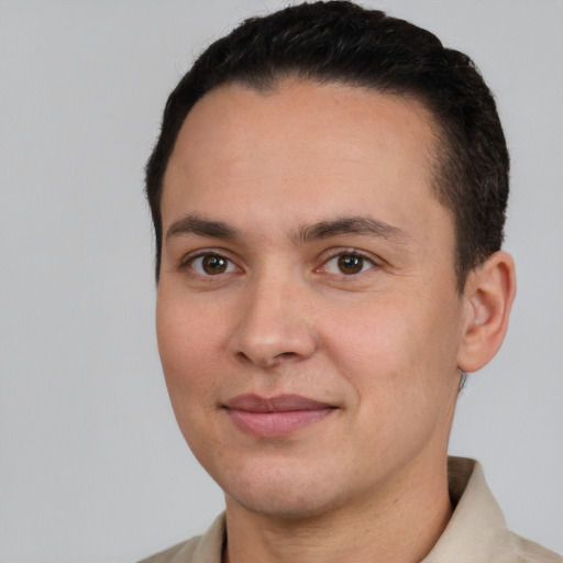 Joyful white young-adult male with short  brown hair and brown eyes