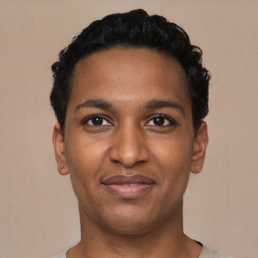 Joyful black young-adult male with short  black hair and brown eyes