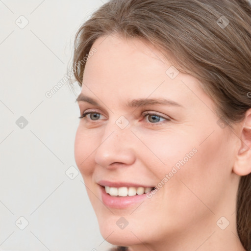 Joyful white young-adult female with medium  brown hair and blue eyes