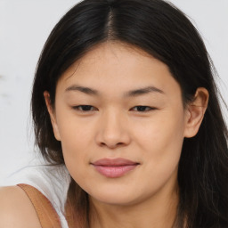 Joyful asian young-adult female with medium  brown hair and brown eyes