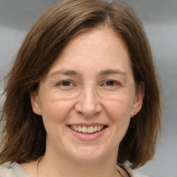 Joyful white adult female with medium  brown hair and brown eyes