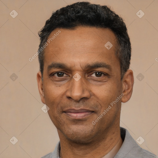 Joyful latino adult male with short  black hair and brown eyes