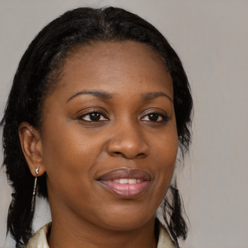 Joyful black young-adult female with medium  brown hair and brown eyes