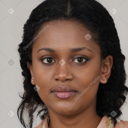 Joyful black young-adult female with long  black hair and brown eyes