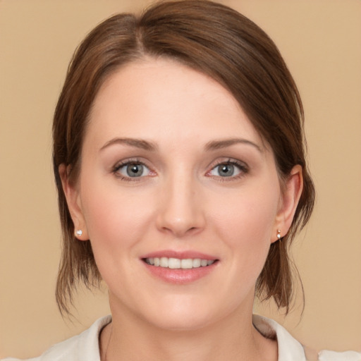 Joyful white young-adult female with medium  brown hair and green eyes