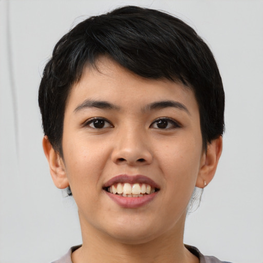 Joyful asian young-adult female with short  brown hair and brown eyes