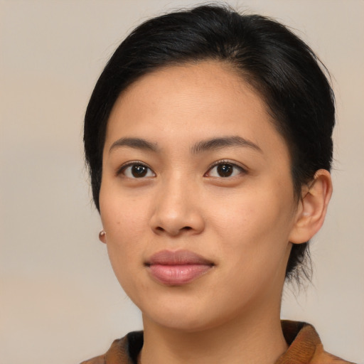 Joyful asian young-adult female with medium  brown hair and brown eyes