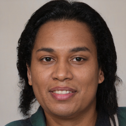 Joyful black adult female with medium  brown hair and brown eyes