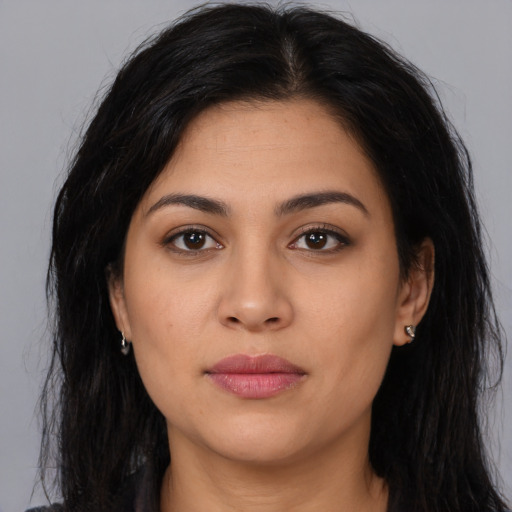 Joyful latino young-adult female with long  brown hair and brown eyes