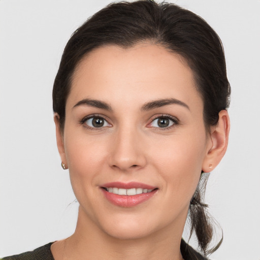 Joyful white young-adult female with medium  brown hair and brown eyes