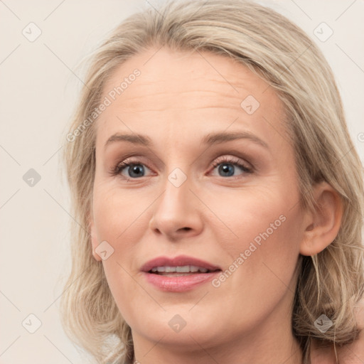 Joyful white young-adult female with medium  brown hair and blue eyes