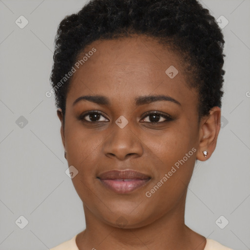 Joyful black young-adult female with short  black hair and brown eyes