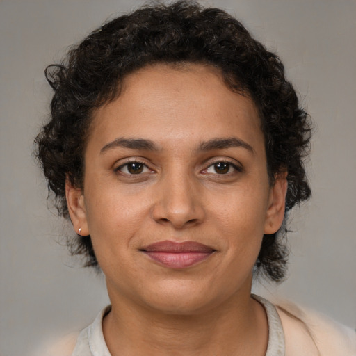 Joyful latino young-adult female with short  brown hair and brown eyes