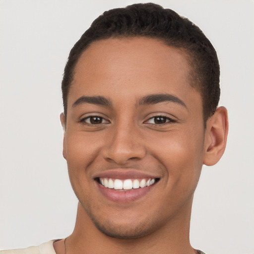 Joyful latino young-adult male with short  brown hair and brown eyes