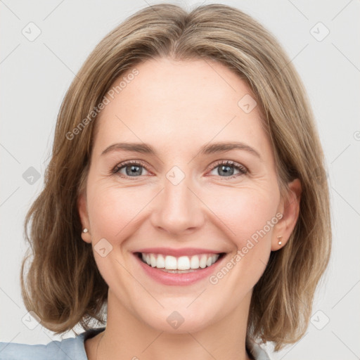 Joyful white young-adult female with medium  brown hair and green eyes