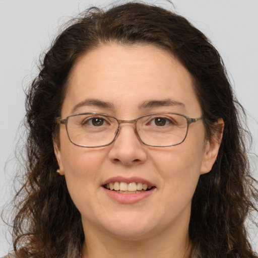 Joyful white adult female with long  brown hair and brown eyes