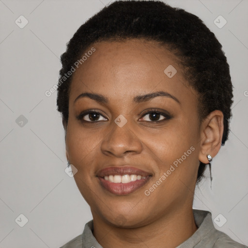Joyful black young-adult female with short  black hair and brown eyes