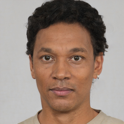 Neutral latino adult male with short  black hair and brown eyes