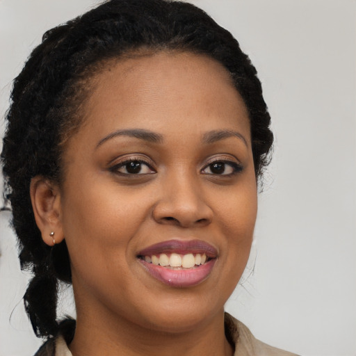 Joyful black young-adult female with long  brown hair and brown eyes