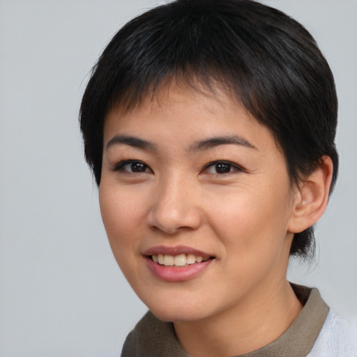 Joyful asian young-adult female with short  brown hair and brown eyes
