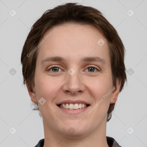 Joyful white young-adult female with short  brown hair and grey eyes