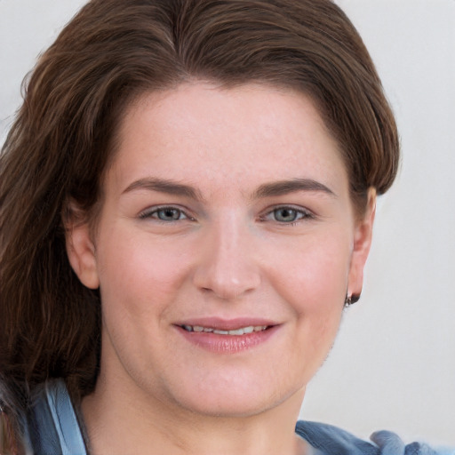 Joyful white young-adult female with short  brown hair and blue eyes