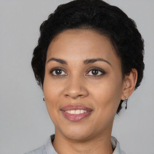 Joyful latino young-adult female with short  black hair and brown eyes