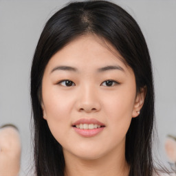 Joyful asian young-adult female with long  brown hair and brown eyes