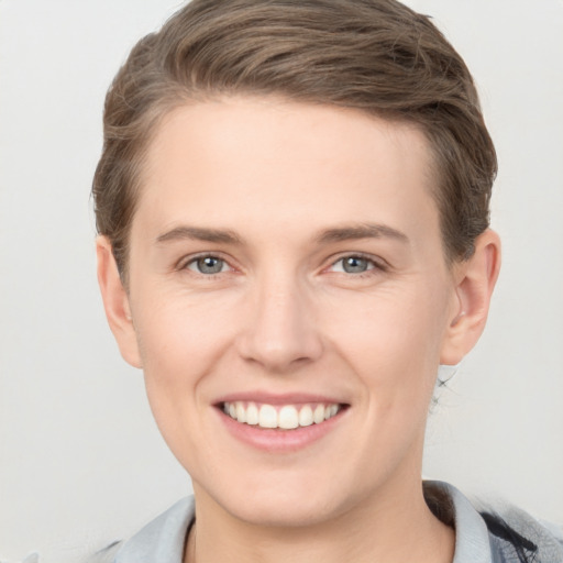 Joyful white young-adult female with short  brown hair and grey eyes