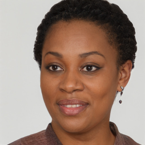 Joyful black adult female with short  brown hair and brown eyes