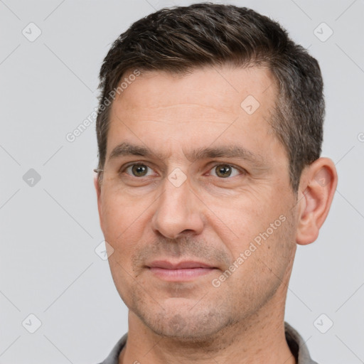 Joyful white adult male with short  brown hair and brown eyes