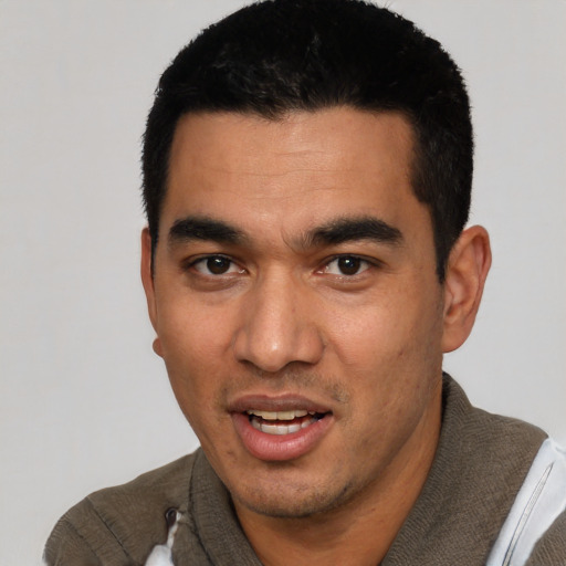 Joyful white young-adult male with short  black hair and brown eyes