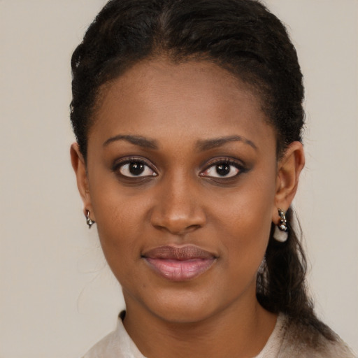 Joyful black young-adult female with short  brown hair and brown eyes