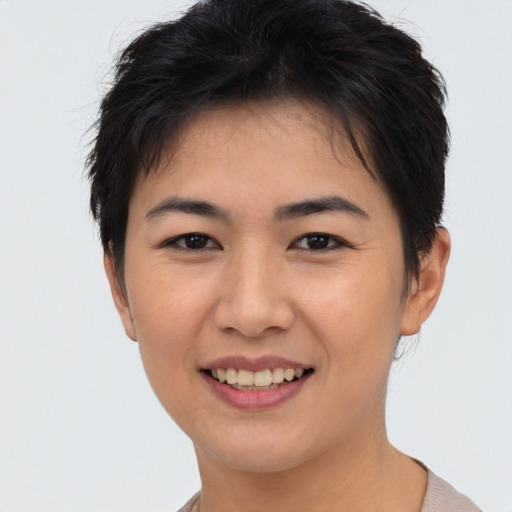 Joyful asian young-adult female with short  brown hair and brown eyes