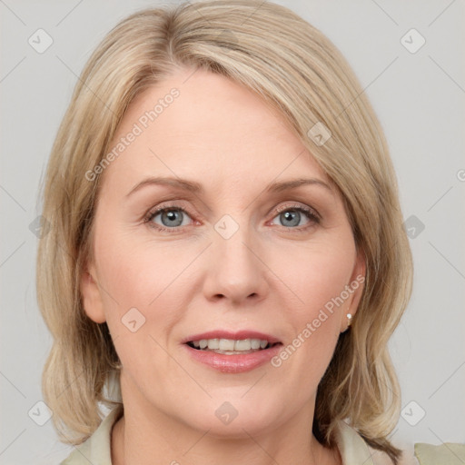 Joyful white adult female with medium  brown hair and blue eyes