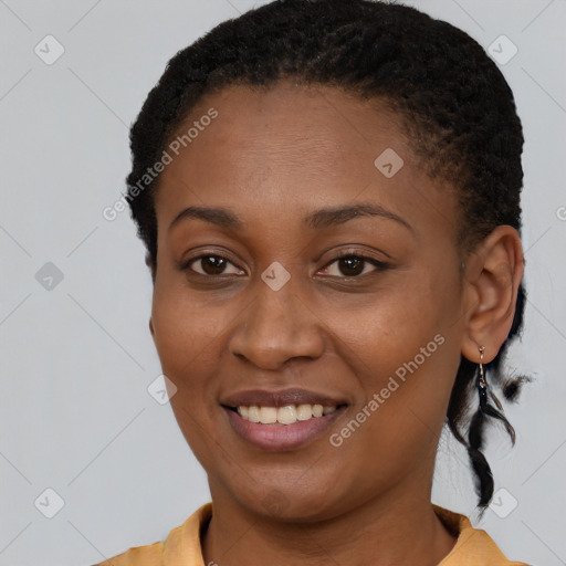 Joyful black young-adult female with short  brown hair and brown eyes