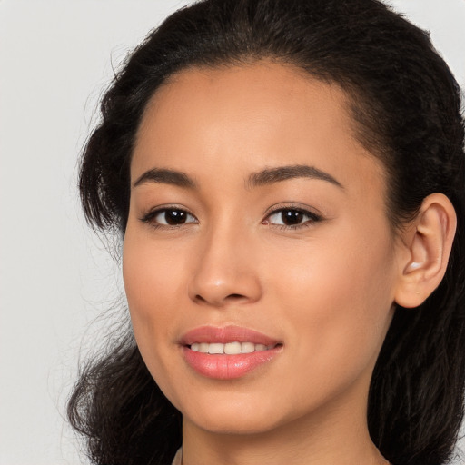 Joyful white young-adult female with long  brown hair and brown eyes