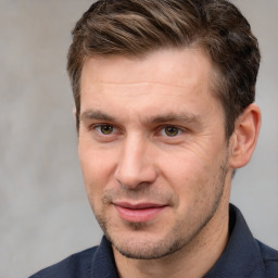 Joyful white adult male with short  brown hair and brown eyes