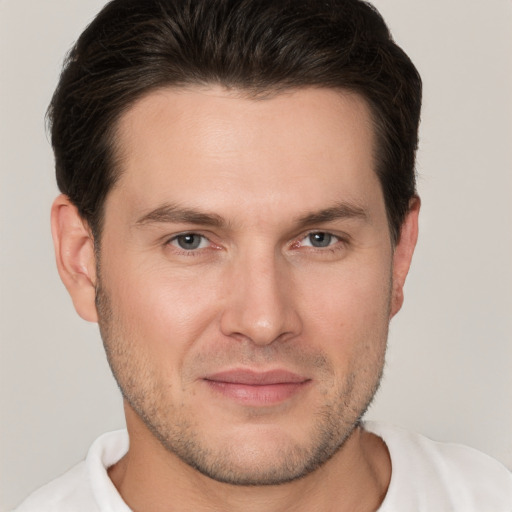 Joyful white young-adult male with short  brown hair and brown eyes