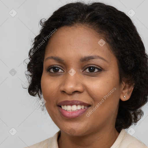 Joyful black young-adult female with long  brown hair and brown eyes